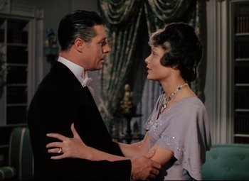 Movie still from “Heaven Can Wait” (1943), directed by Ernst Lubitsch – An older man and a younger woman holding hands; Medium shot, Over the shoulder angle