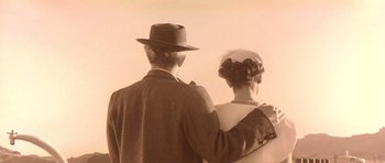 Movie still from “Heavenly Creatures” (1994), directed by Peter Jackson – An older man and a younger woman standing next to each other; Close Up shot, Low angle