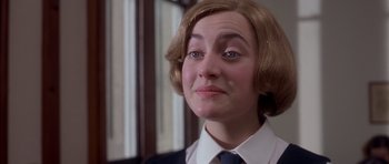 Movie still from “Heavenly Creatures” (1994), directed by Peter Jackson – A woman in a suit and tie looking at the camera; Close Up shot, Low angle