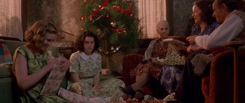 Movie still from “Heavenly Creatures” (1994), directed by Peter Jackson – Two women sitting in front of a christmas tree; Medium shot, High angle