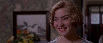 Movie still from “Heavenly Creatures” (1994), directed by Peter Jackson – A person smiling; Close Up shot, Over the shoulder angle