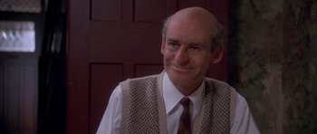 Movie still from “Heavenly Creatures” (1994), directed by Peter Jackson – An older man wearing a vest and a tie; Close Up shot, Over the shoulder angle