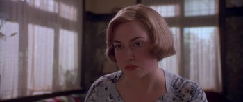 Movie still from “Heavenly Creatures” (1994), directed by Peter Jackson – A person with short brown hair; Close Up shot, Over the shoulder angle