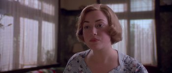 Movie still from “Heavenly Creatures” (1994), directed by Peter Jackson – A person with short brown hair; Close Up shot, Over the shoulder angle