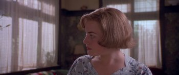 Movie still from “Heavenly Creatures” (1994), directed by Peter Jackson – A person with short brown hair; Close Up shot, Over the shoulder angle