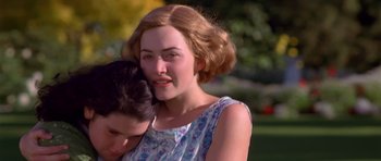 Movie still from “Heavenly Creatures” (1994), directed by Peter Jackson – A young woman holding onto a young man's shoulder; Close Up shot, High angle