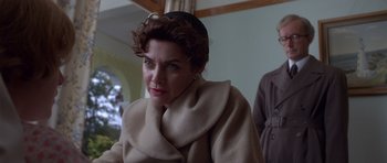 Movie still from “Heavenly Creatures” (1994), directed by Peter Jackson – A person wearing a coat and a hat; Close Up shot, Over the shoulder angle