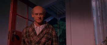 Movie still from “Heavenly Creatures” (1994), directed by Peter Jackson – A wax statue of a man in a plaid robe; Medium shot, Low angle