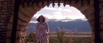Movie still from “Heavenly Creatures” (1994), directed by Peter Jackson – A woman standing in front of a mountain range; Wide shot, Low angle