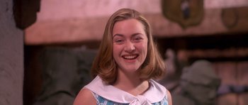 Movie still from “Heavenly Creatures” (1994), directed by Peter Jackson – A young woman smiles brightly while wearing a blue dress; Close Up shot, High angle
