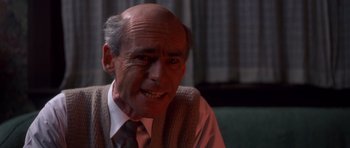 Movie still from “Heavenly Creatures” (1994), directed by Peter Jackson – An older man wearing a tie and a vest; Close Up shot, Low angle