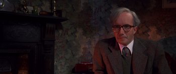 Movie still from “Heavenly Creatures” (1994), directed by Peter Jackson – An older man wearing a suit and tie; Close Up shot, Over the shoulder angle