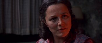 Movie still from “Heavenly Creatures” (1994), directed by Peter Jackson – A woman's face in a dark room; Close Up shot, Over the shoulder angle