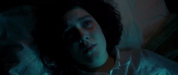 Movie still from “Heavenly Creatures” (1994), directed by Peter Jackson – A young woman crying in a dark room; Close Up shot, Overhead angle