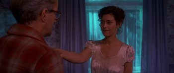 Movie still from “Heavenly Creatures” (1994), directed by Peter Jackson – A woman in a white dress and a man in glasses; Medium shot, Over the shoulder angle