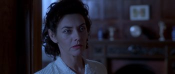 Movie still from “Heavenly Creatures” (1994), directed by Peter Jackson – A person wearing a white shirt; Close Up shot, Over the shoulder angle