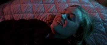 Movie still from “Heavenly Creatures” (1994), directed by Peter Jackson – A woman laying on the ground with her mouth open; Close Up shot, Overhead angle