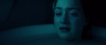 Movie still from “Heavenly Creatures” (1994), directed by Peter Jackson – A woman crying in a bathtub at night time; Close Up shot, Overhead angle