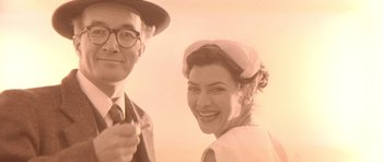 Movie still from “Heavenly Creatures” (1994), directed by Peter Jackson – An old photo of a man and a woman smiling; Close Up shot, Low angle