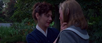 Movie still from “Heavenly Creatures” (1994), directed by Peter Jackson – A woman is touching the face of another woman; Close Up shot, Over the shoulder angle