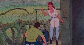 Movie still from “Heavy Metal” (1981), directed by Gerald Potterton – An animated scene of a man and a woman in front of a chain link fence; Wide shot, Low angle