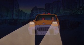 Movie still from “Heavy Metal” (1981), directed by Gerald Potterton – A car driving down a street at night with headlights on; Extreme Wide shot, Low angle