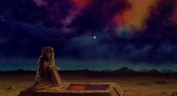 Movie still from “Heavy Metal” (1981), directed by Gerald Potterton – An image of an ancient statue in the middle of the desert; Extreme Wide shot, Low angle