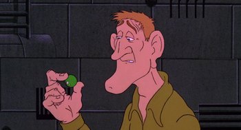 Movie still from “Heavy Metal” (1981), directed by Gerald Potterton – An animated man holding a green object in his hand; Close Up shot, High angle