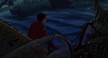 Movie still from “Heavy Metal” (1981), directed by Gerald Potterton – A man sitting on top of a boat in the water; Medium shot, High angle