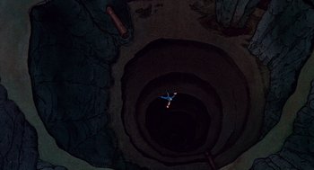 Movie still from “Heavy Metal” (1981), directed by Gerald Potterton – An aerial view of a person jumping in a hole; Extreme Wide shot, Overhead angle