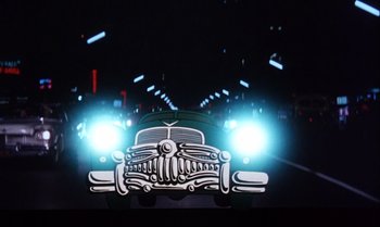 Movie still from “Heavy Traffic” (1973), directed by Ralph Bakshi – A car that is on the road at night time; Wide shot, Low angle