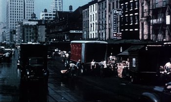 Movie still from “Heavy Traffic” (1973), directed by Ralph Bakshi – An old photo of a street scene with a truck and people; Extreme Wide shot, Low angle