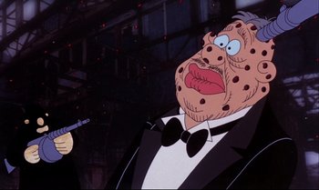 Movie still from “Heavy Traffic” (1973), directed by Ralph Bakshi – A man in a tuxedo holding a fake gun; Close Up shot, Low angle