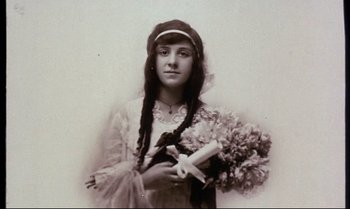 Movie still from “Heavy Traffic” (1973), directed by Ralph Bakshi – An old photo of a woman holding a bouquet of flowers; Close Up shot, High angle