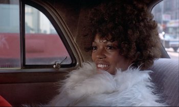 Movie still from “Heavy Traffic” (1973), directed by Ralph Bakshi – A woman in a white fur coat sitting in the back of a car; Close Up shot, Low angle