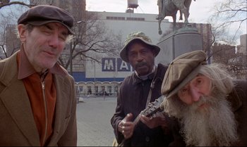 Movie still from “Heavy Traffic” (1973), directed by Ralph Bakshi – A group of people that are standing in the street; Medium shot, Low angle