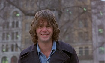 Movie still from “Heavy Traffic” (1973), directed by Ralph Bakshi – A young man with long hair and a blue shirt; Close Up shot, Low angle