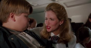 Movie still from “Heavyweights” (1995), directed by Steven Brill – A woman with long blonde hair and red lipstick on her mouth; Close Up shot, Over the shoulder angle