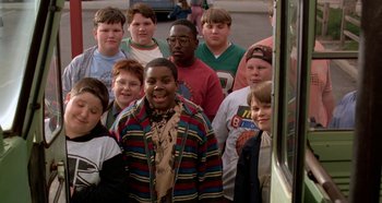 Movie still from “Heavyweights” (1995), directed by Steven Brill – A group of young people standing next to each other; Medium shot, High angle
