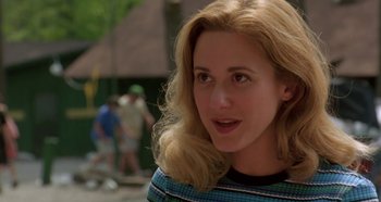 Movie still from “Heavyweights” (1995), directed by Steven Brill – A person with long blonde hair; Close Up shot, Over the shoulder angle