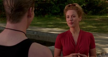 Movie still from “Heavyweights” (1995), directed by Steven Brill – A woman in a red shirt talking to a man in a black shirt; Medium shot, Over the shoulder angle