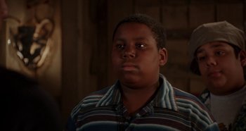Movie still from “Heavyweights” (1995), directed by Steven Brill – A young man in a striped shirt looking at the camera; Close Up shot, Over the shoulder angle