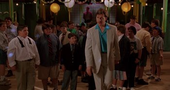 Movie still from “Heavyweights” (1995), directed by Steven Brill – A group of young men standing in front of a crowd of people; Wide shot, Over the shoulder angle