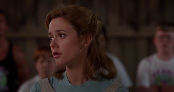 Movie still from “Heavyweights” (1995), directed by Steven Brill – A young woman with long brown hair looking to her left; Close Up shot, Over the shoulder angle