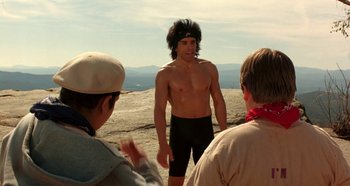 Movie still from “Heavyweights” (1995), directed by Steven Brill – A group of men standing on top of a mountain; Medium shot, Over the shoulder angle