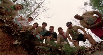 Movie still from “Heavyweights” (1995), directed by Steven Brill – A group of young people standing on top of a tree; Wide shot, Low angle