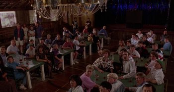 Movie still from “Heavyweights” (1995), directed by Steven Brill – A group of people sitting at tables in a room; Wide shot, High angle