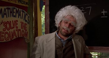 Movie still from “Heavyweights” (1995), directed by Steven Brill – A man in a white wig and a suit; Medium shot, Over the shoulder angle