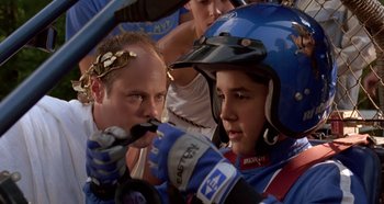 Movie still from “Heavyweights” (1995), directed by Steven Brill – A man and a boy in a race car; Close Up shot, Over the shoulder angle