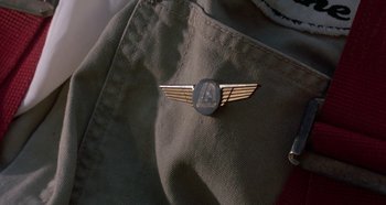 Movie still from “Heavyweights” (1995), directed by Steven Brill – A pin on a jacket; Extreme Close Up shot, Overhead angle
